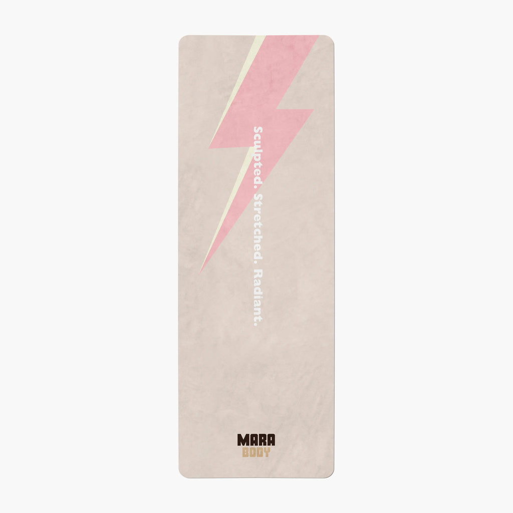 Yoga mat with pink lightning bolt design and brand name MARA BDOY on beige background