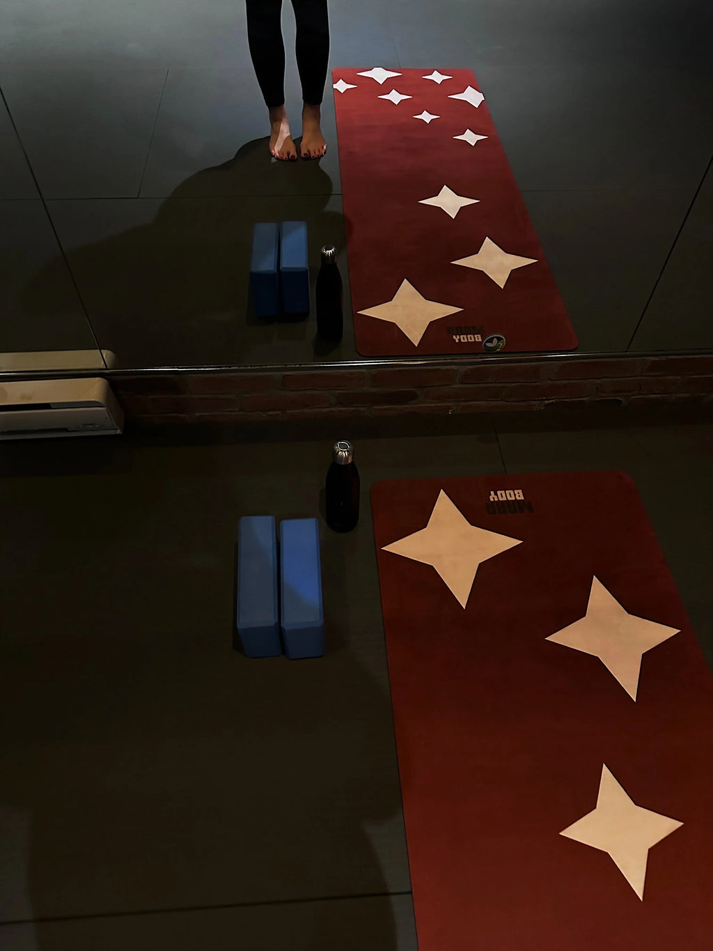 Yoga mat with star patterns on a dark floor in aesthetic yoga and pilates studio