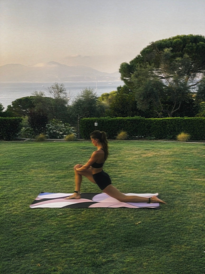 Person practicing yoga on a grassy field with a scenic background on emilio pucci inspired designer yoga mat